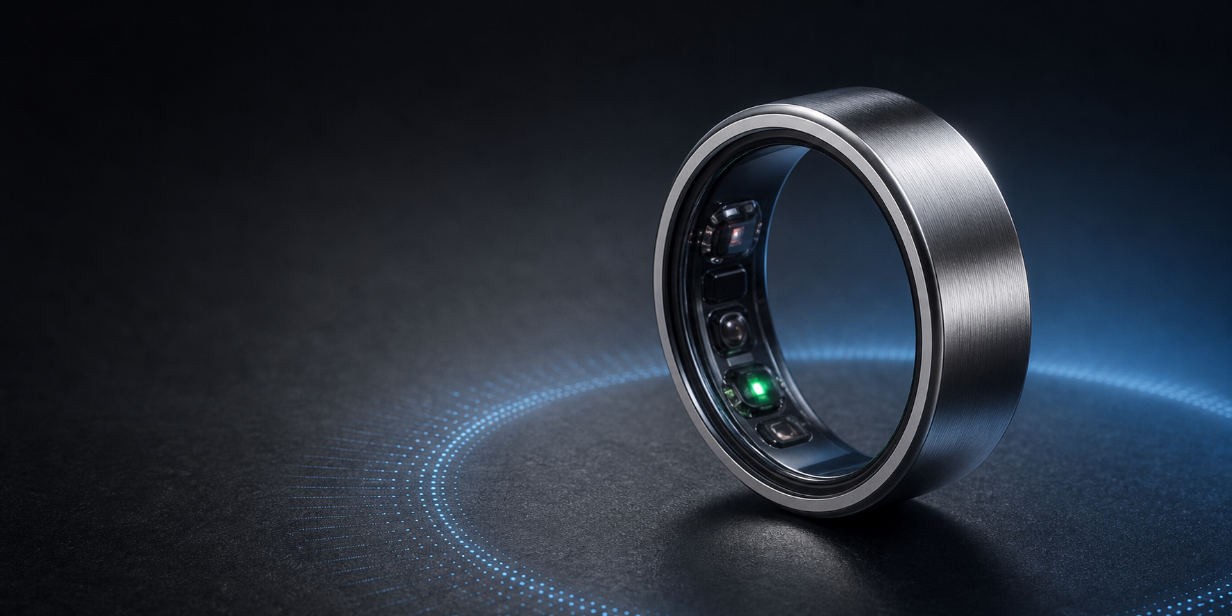 A titanium smart ring with inner biosensors on a dark studio surface